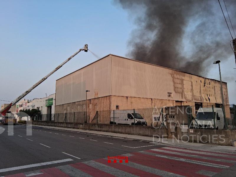 Els Bombers continuen remullant la nau industrial de Vilamalla afectada per un incendi